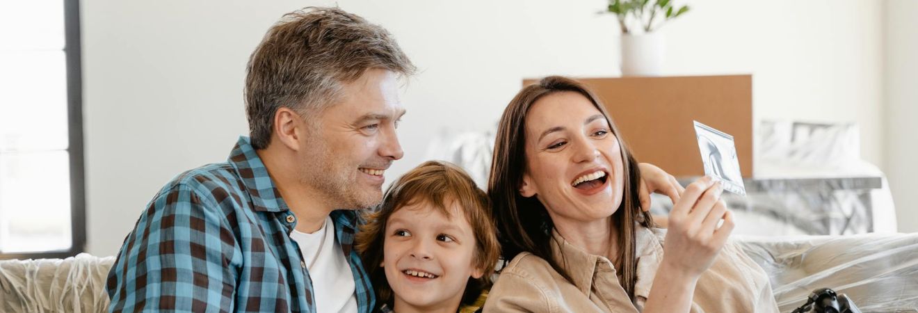 a family of three celebrating moving with the help of movers hollywood fl