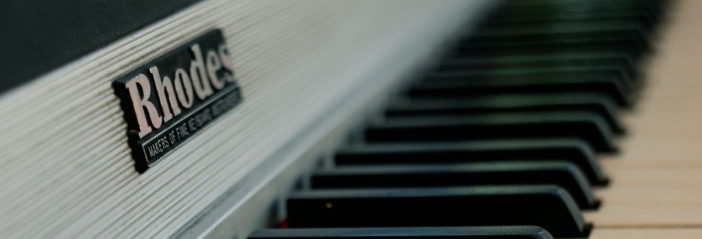 a side view of a white grand piano