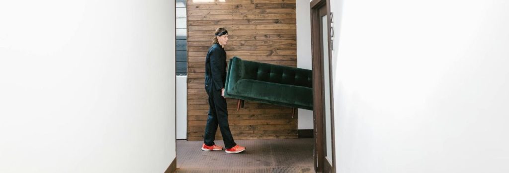 Movers carrying a sofa.
