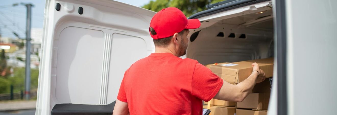 a man packing boxes in the van