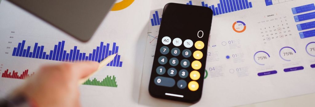 a calculator on a table used to calculate what increases the moving costs