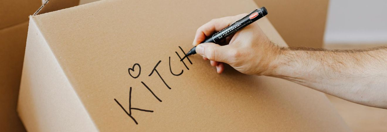 Person writing on a box