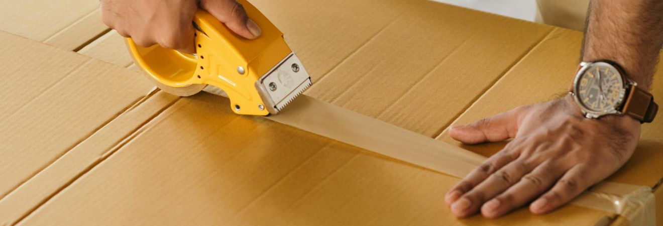a member of fort lauderdale packing services taping a box