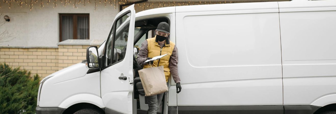 a man carrying a box from the van
