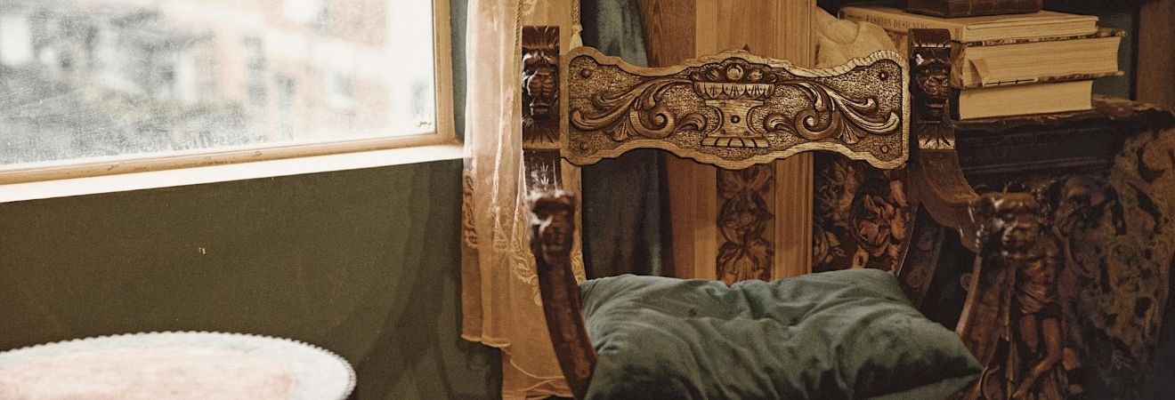 an antique chair next to a table