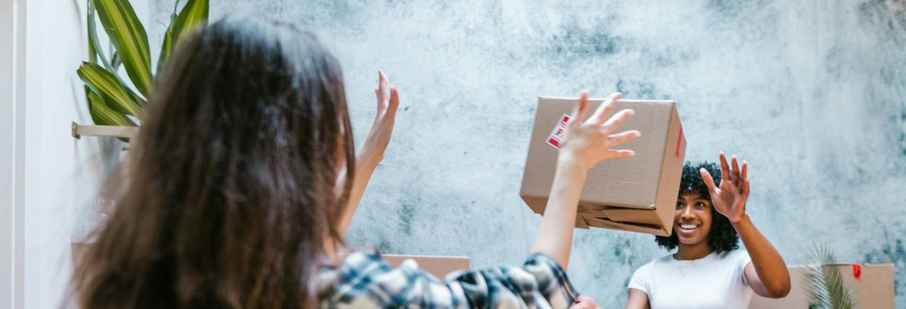 two girl playing with a box