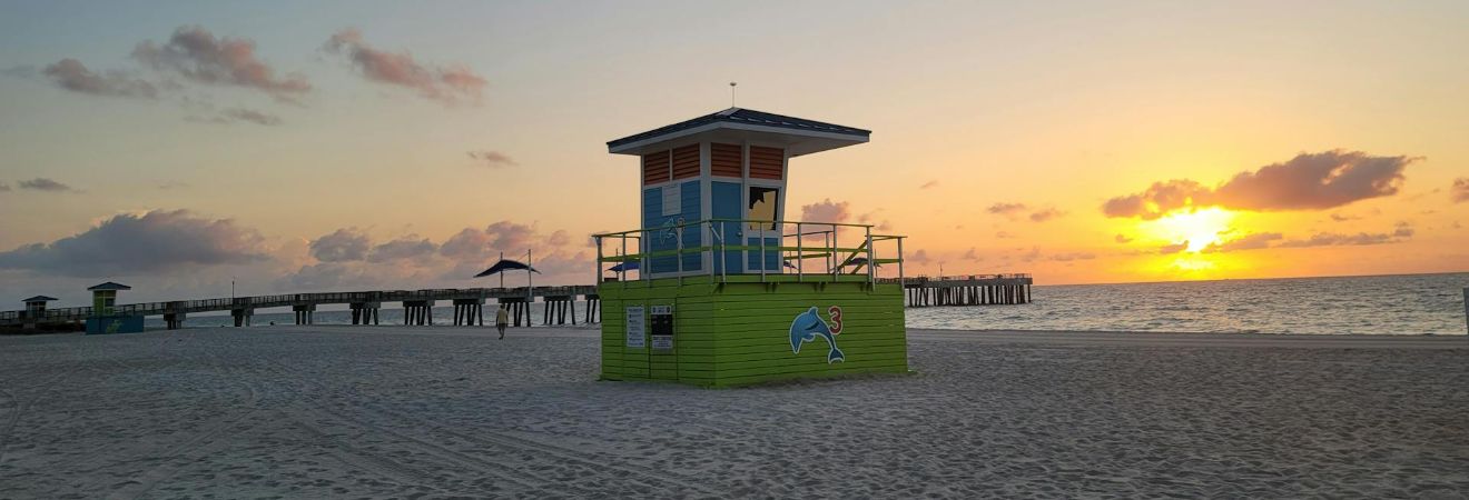 Scenic sunrise at pompano beach with lifeguard tower