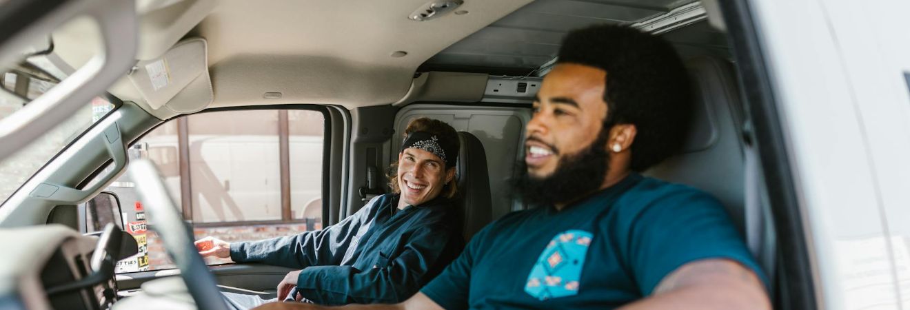 two members of the most most reliable moving companies fort lauderdale residential moves sitting in a moving van