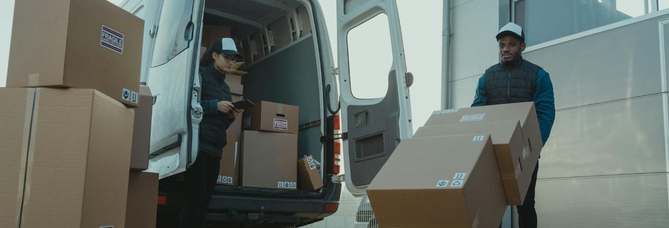 Movers carrying boxes into a truck.