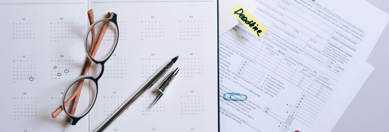 List and calendar with office supplies